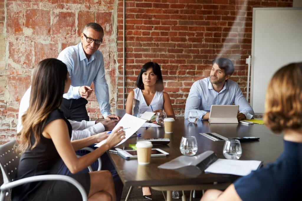 A group of business professionals meeting in a boardroom.