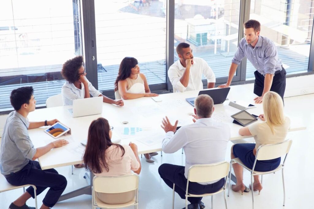 A group of people around a table exchanging advice.